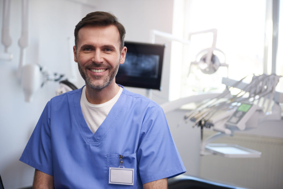 Portrait of smiling dentist in dentist's office smiling dentist