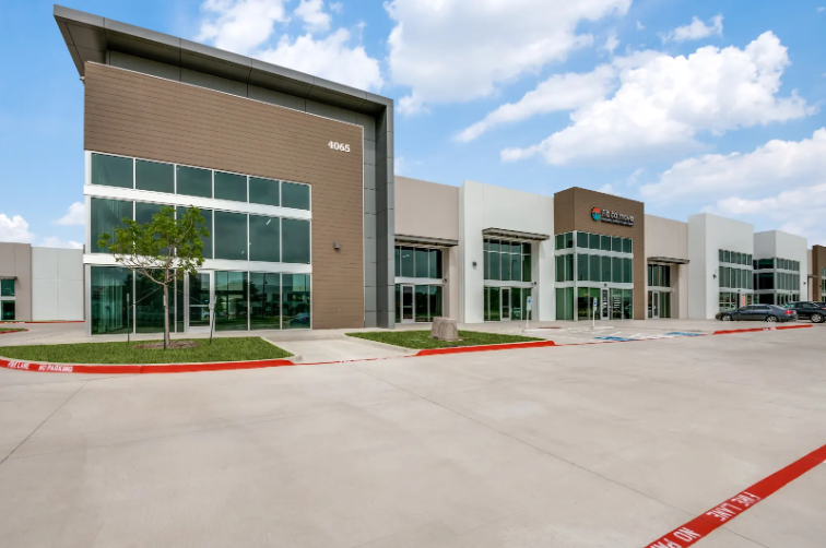 Retail space for lease Plano TX at Plano Business Park showing modern commercial building exterior with glass windows and professional landscaping