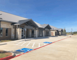 Medical office Prosper TX at Whispering Gables showing accessible parking spaces and side exterior view